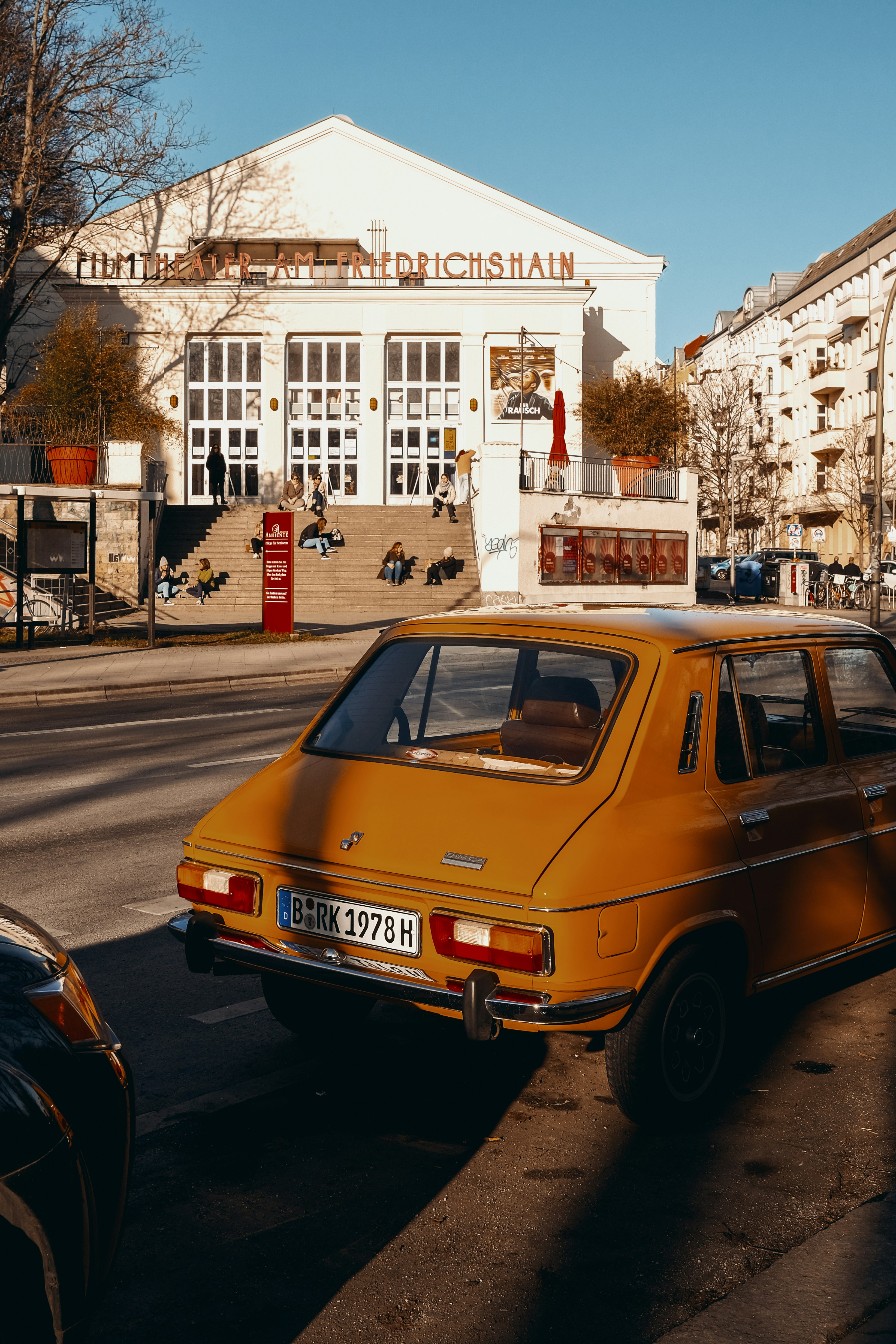 orange volkswagen beetle on road during daytime